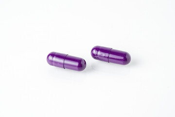 Two medicine capsule pills, supplement isolated on with background
