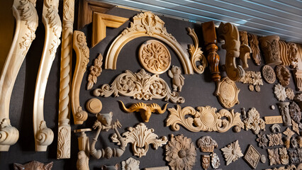 Wooden pattern elements for furniture, carving element. furniture in classic style. white color wood with gold trim. patina. carving. small depth of field. luxury furniture. use as background.
