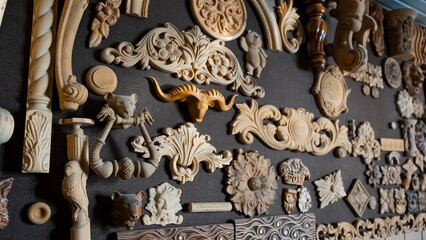 Wooden pattern elements for furniture, carving element. furniture in classic style. white color wood with gold trim. patina. carving. small depth of field. luxury furniture. use as background.
