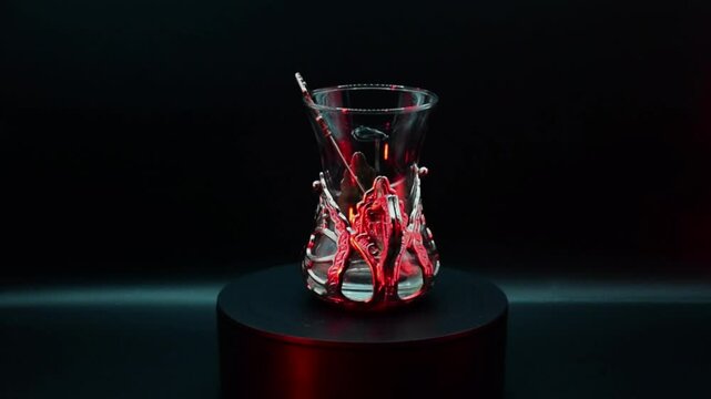 Empty spinning Turkish armudu glass for Turkish tea isolated on black background. 