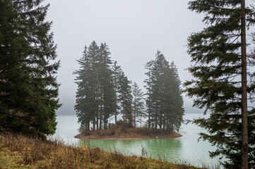 Autumn of fog and mist on the lake of Cave del Predil