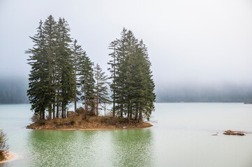 Autumn of fog and mist on the lake of Cave del Predil