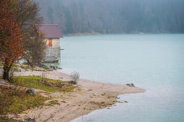 Autumn of fog and mist on the lake of Cave del Predil