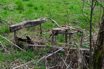 a broken wooden table and a bench