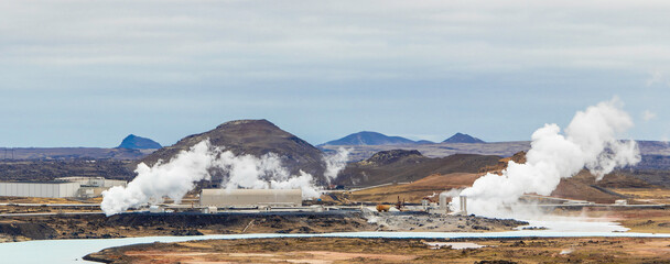 A large geothermal power plant is spewing steam into the air. Reykjanes power station