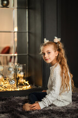 portrait of a blonde girl against the background of a New Year tree. christmas.family holiday