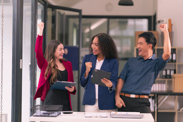 Group of young business people, startup business team from different nationalities meeting in modern office and brainstorming, working on laptops and tablets with financial chart documents.