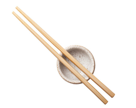 A pair of bamboo chopsticks placed across a speckled ceramic bowl. A minimalist and traditional setup for Asian cuisine dining. Isolated on transparent background, png. - Powered by Adobe