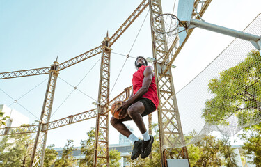 Young basketball player training at the court