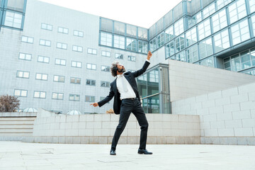 Young entrepreneur business man listening to music and dance