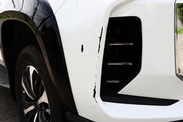 Scratches and scuffs on rear bumper of new car