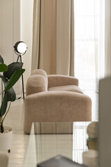 White wood laminate parquet flooring luxury living room with beige sofa, coffee table, indoor plant