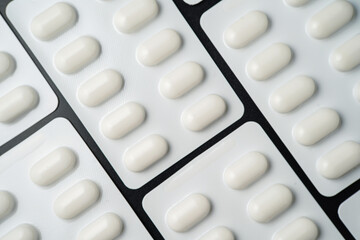 Pills Medicine tablet capsules in blister pack on a black background