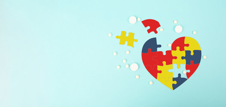 ASD autism spectrum disorder, treatment medical pills, deficits in social communication, heart with colorful jigsaw or puzzle pieces
