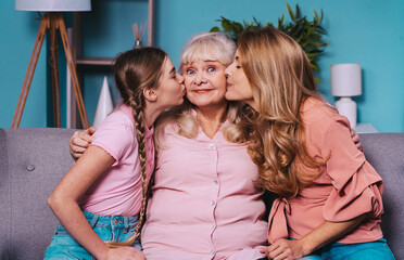 Cinematic portrait image of grandmother, mother and grandaughter sitting on the couch