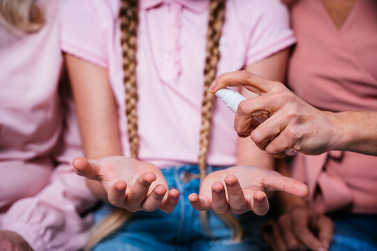 Cinematic portrait image of grandmother, mother and grandaughter sitting on the couch