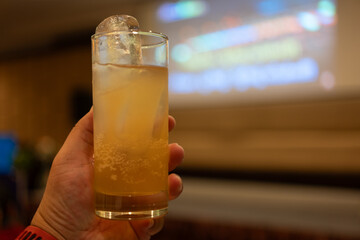Men hand holding a glass of alcoholic drink