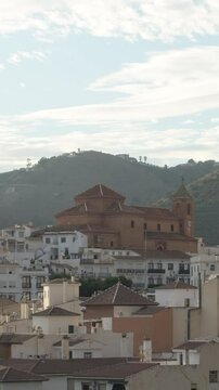 Torrox church view from back surrounded of white houses. 4K Vertical
