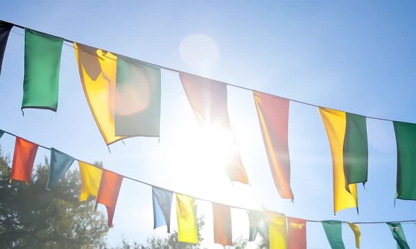 Bunting flags hanging on ropes blowing in the wind.