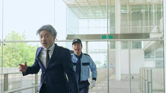 警備員に追いかけられるミドル男性ビジネスパーソン