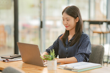 Fototapeta premium Asian business woman working happily at the office