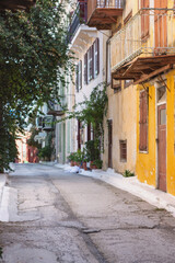 Wandering through Nafplio's peaceful alley, you encounter vibrant buildings adorned with greenery and balconies, inviting a moment of tranquility and exploration.