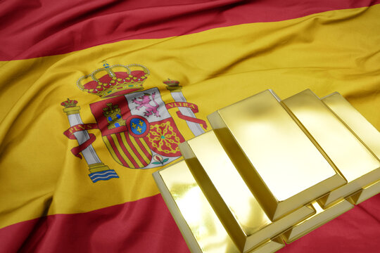 shining golden bullions on the spain flag background.