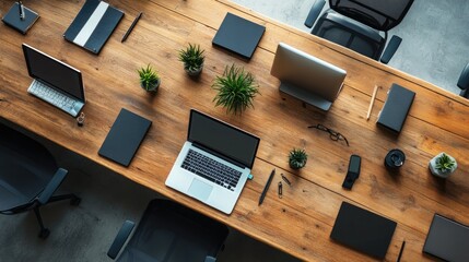 Naklejka premium A high-angle view of a modern business workspace with multiple devices and office accessories neatly arranged.