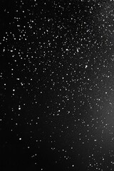 Black background with small white dots creating a striking and simple pattern with depth and contrast