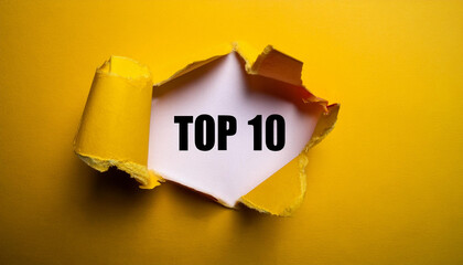 Torn paper revealing text Top 10, bright background. Business concept.