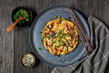 Japanese pancake with cabbage on a plate, top view
