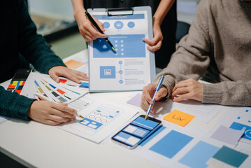  UX developer and ui designer brainstorming about mobile app interface wireframe design with...