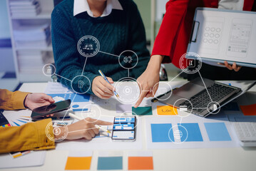 Close up view of UI developer team brainstorming on their project with laptop, smartphone and digital tablet.