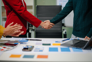 Close up view of UI developer team brainstorming on their project with laptop, smartphone and digital tablet.