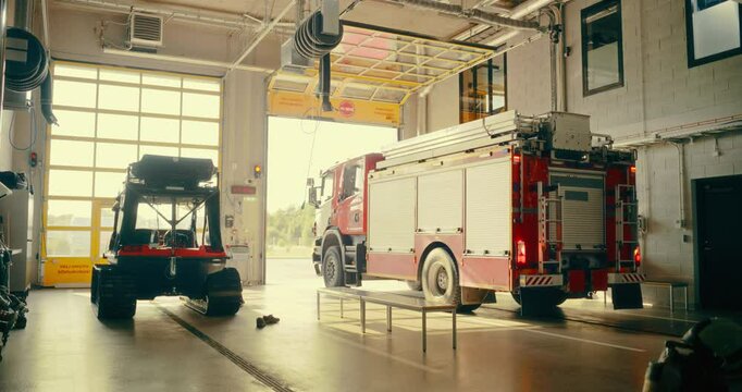 Fire Truck Exits the Fire Department, Highlighting the Urgency and Readiness of Firefighters Responding to an Emergency Call. Team Drive Off to Handle a Critical Situation. Warm Color Grade