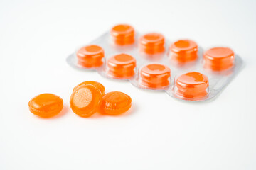 tablets lozenges in a blister pack for coughing in the throat white background