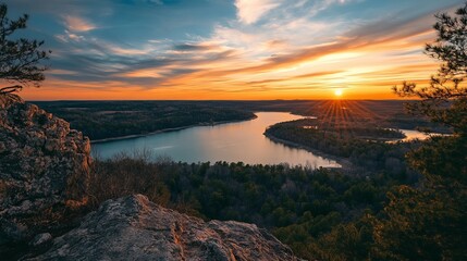 Perched at the top of a hill, a breathtaking view unfolds over a serene lake nestled below, offering a "top of the world" perspective. 