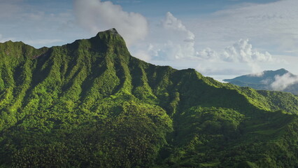 Sunny tropical island green rainforest mountain peaks. Showcasing vibrant colors and fluffy clouds....