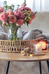 Cozy home interior with flowers dahlias. Autumn home comfort.