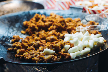 Korean Street Food - Dakgangjeong, Sweet Crispy Korean Fried Chicken, variety of different traditional food selection in Seoul, South Korea, night street market with local vendor stalls cooking