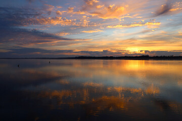 Obraz premium View of the sunset over the sea in summer time in Wales, UK