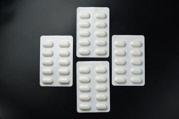 Tablet pills blister Medicine capsules on a black background