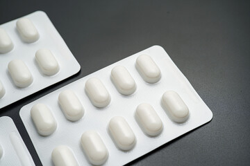 Tablet pills blister Medicine capsules on a black background