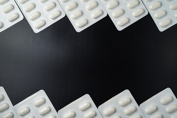 Antibiotic pills Medicine tablet capsules in blister pack on a black background