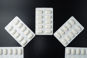 Antibiotic pills Medicine tablet capsules in blister pack on a black background