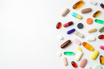 A lot of colorful medication pills capsules tablets softgel supplements, fish oil, vitamin, omega 3