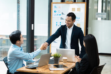 Business Meeting in Modern Office with Professionals Shaking Hands and Discussing Strategy