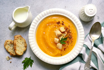 Delicious pumpkin soup with croutons. Top view with copy space.