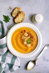 Delicious pumpkin soup with croutons. Top view with copy space.