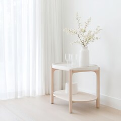 A white table with a vase of flowers and two wine glasses on it